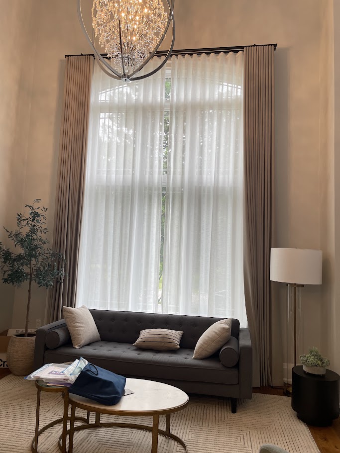 Elegant living room with tall sheer curtains and chandelier