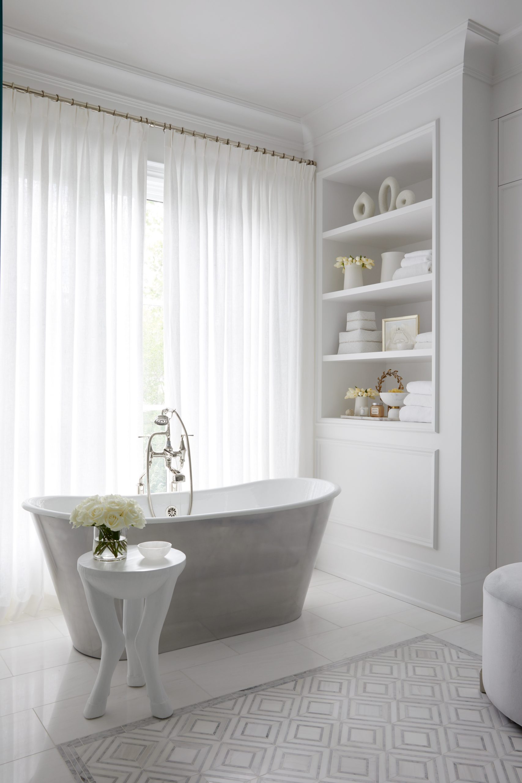 Luxury bathroom with sheer curtains and freestanding tub