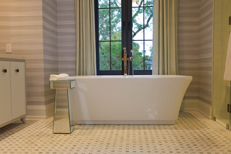 Luxury bathroom with freestanding tub and striped drapery