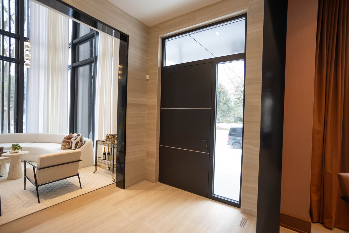 Modern foyer with double-height windows and ripplefold sheers