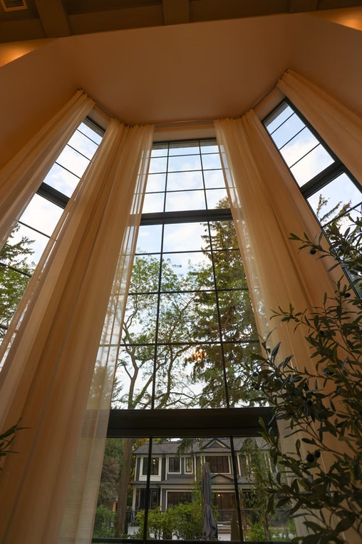 Triple-height foyer with dramatic floor-to-ceiling sheers
