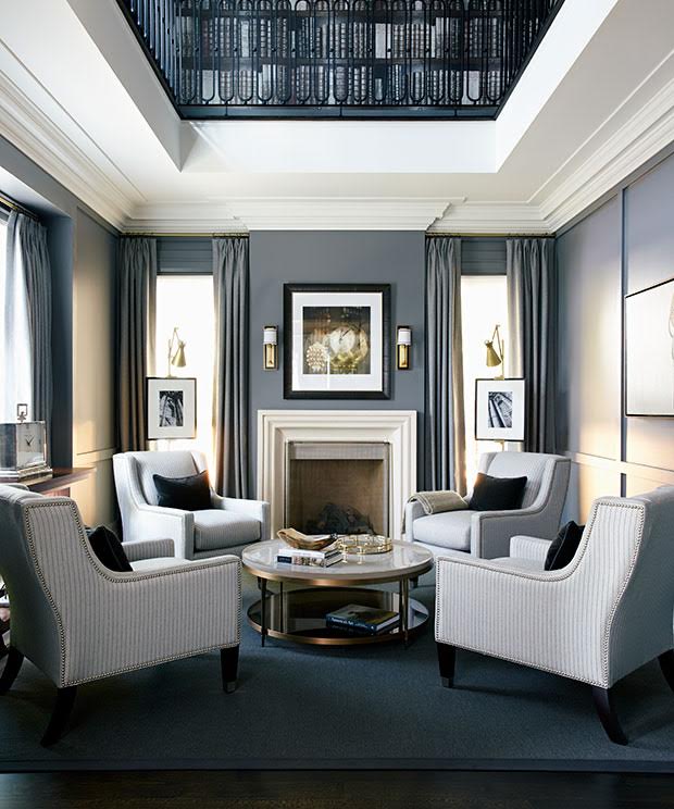 Dramatic formal living room with charcoal drapery and gold accents